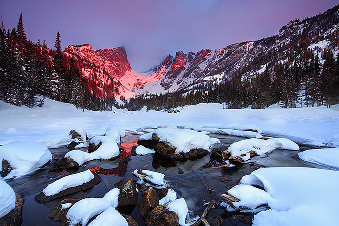 Spring sunrise on Dream Lake. It's been a long cold spring in Rocky Mountain National Park. I took this image of Dream Lake the first week of May. The outlet to Dream Lake had just begun to thaw out allowing for me to capture a slight reflection of Hallet Peak in the icy waters. Technicial Details: Canon EOS 5D Mark III, 17mm TS-E F4 L