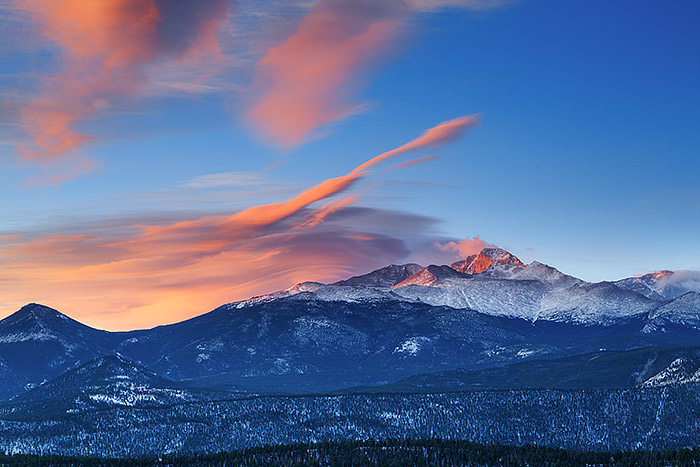 Longs Peak greets a beautiful but windy morning in Rocky Mountain National Park. Fresh snow has fallen on Rocky's highest peak and the high winds have formed beautiful lenticular clouds which glow in the early morning light. Technical Details: Canon EOS 5D Mark III, 70-300mm F4-5.6 IS L 