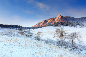 The first rays of sunlight dapple the Flatirons in pink as clouds glide over the mountain peaks and snow coated pines of Chautauqua Park. Technical Details: Canon EOS 5D Mark III, 24-70mm F4 IS L 