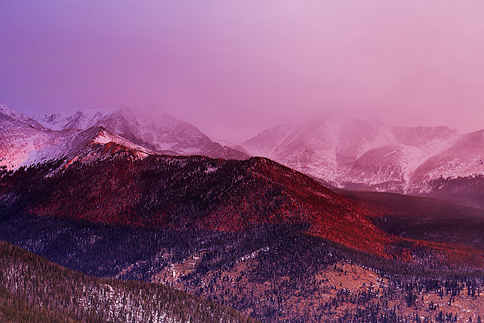 Sunrise unfolds over the Mummy Range and Ypsilon Mountain on the winter solstice. Snow squalls and clouds are seen blowing over the peaks of the Mummy Range as a colorful magenta sunrise briefly lights the mountainsides. Technical Details: Canon EOS 5D Mark III, 24-70mm F4 IS L 