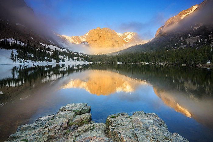 The Cathedral Wall glows with the first rays of sun as the fog lifts from The Loch and Loch Vale. These rare moments are what make Rocky Mountain National Park such a magical place. Technical Details: Canon EOS 5D Mark III, 17mm TS-E F4 L 