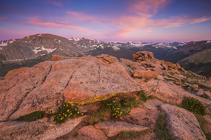 Sunrises from the top of Trail Ridge Road exemplify the Rocky Mountain National Park experience. Here the skies over Forest Canyon explode with color as wildflowers grow between the rocks and boulders found above treeline. Technical Details: Canon EOS 5D Mark III, 16-35mm F4 IS L 