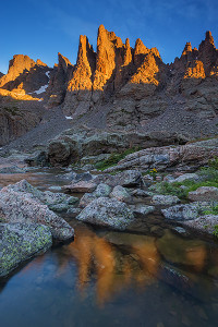 The famous 'Sharkstooth' formation glows with the new mornings sun as it reflects in the waters of Sky Pond. Technical Details: Canon EOS 5D Mark III, 15-35mm F4 IS L 