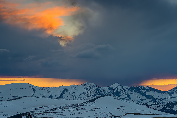 A beautiful end to and evening on Trail Ridge Road in Rocky Mountain National Park. The sun is seen setting over Shipler Peak as clouds and some virga drift over the Colorado skies. The snowpack still present on the mountains of Rocky Mountain National Park this late into June was an added bonus for photographers. Technical Details: Nikon D810, Nikkor 28-300mm F4.5-5.6 ED VR lens