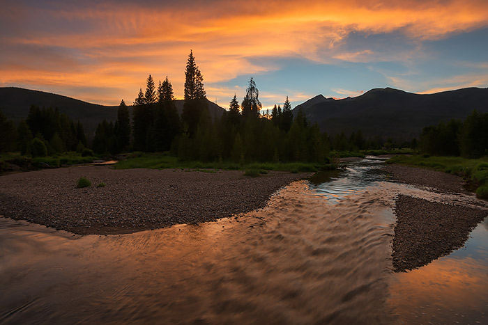The summer photography season in Rocky Mountain National Park is currently in full swing. To borrow a golf phrase we are entering summer's back nine in Rocky. Wildflowers still look great in the park and now is the time to get out and hike to your favorite backcountry destination. I photographed this beautiful sunset last week on the west side of Rocky Mountain National Park. The beautiful colors of sunset reflect in the placid waters of the Colorado River as seen from the Kawuneeche Valley. Technical Details: Nikon D810, 16-35mm F4 ED VR