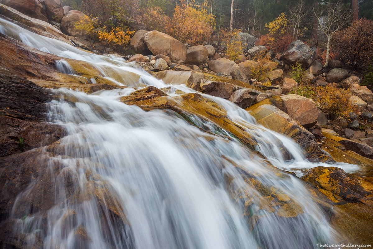 Alluvial Fan Falls cascades down the rocky landscape formed by the Roaring River. It's a cold late October day in Rocky Mountain...