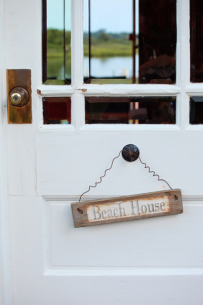 A Door to a Southampton, New York beach house welcomes visitors with a view of Shinnecock Bay