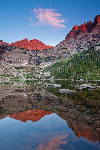 McHenry's Peak turns a brilliant red as the morning sun illuminates the granite peak deep within Rocky Mountain National Park...