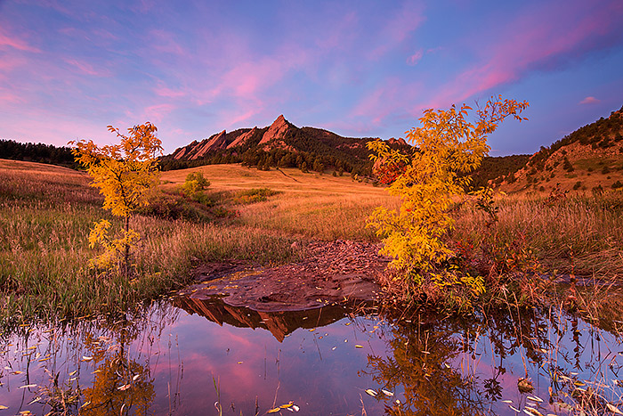 Pastel hue's light the skies over Boulder and the Flatiron formation on a spectacular autumn morning in Chautauqua Park. The...