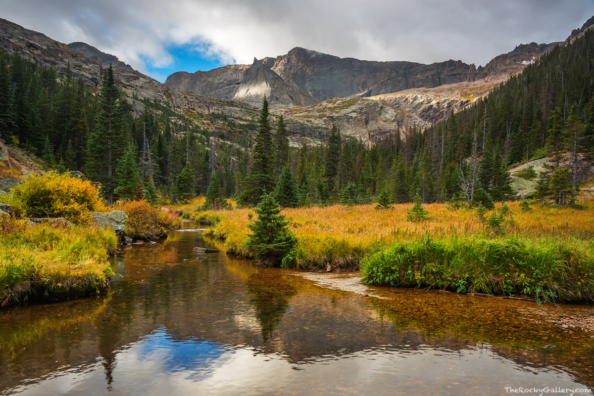 Glacier Creek flows downstream below Black Lake on an autumn day in Rocky M...