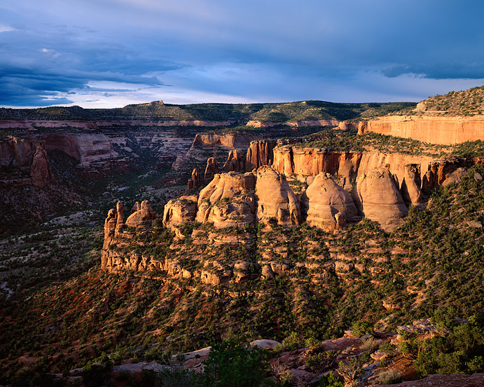 Storm clouds drift over the Coke Ovens in the Colorado National Monument. A small window of light at sunrise allowed for this...