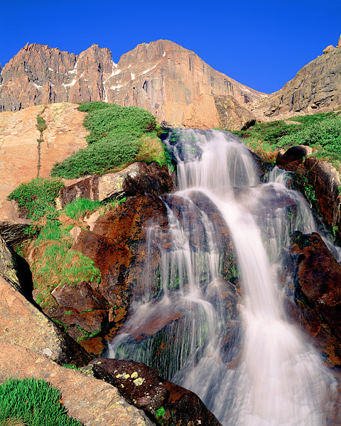 14,255 ft. Longs Peak rises above Columbine Falls. Columbine Falls sits just below Chasam Lake and the base of the Diamond. The...