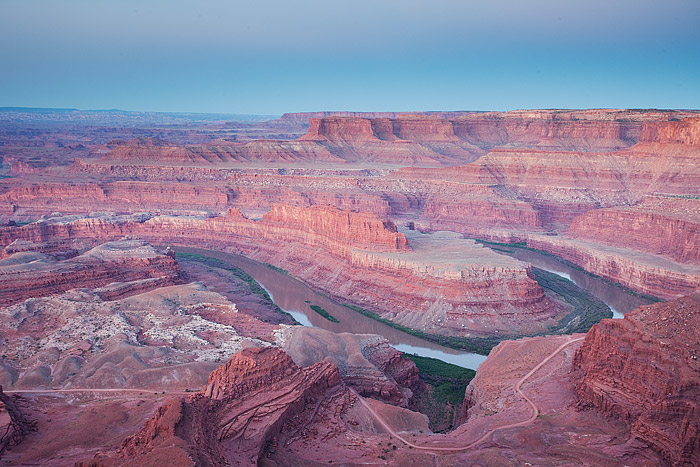 Daybreak is quickly approaching the red rocks of Canyonlands and the Colorado River. The shadow of the earth can be seen receeding...