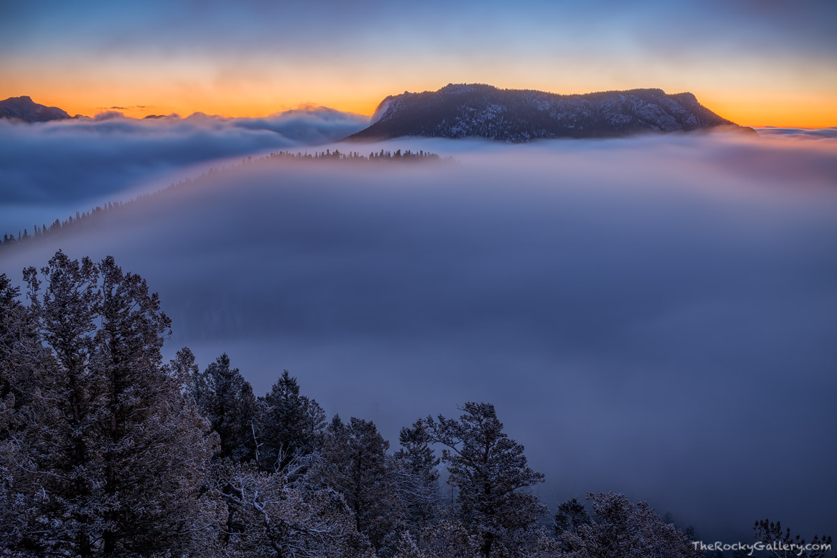 Clouds hug the sides of Deer Mountain in the distance as a winter storm moves on from Rocky Mountain National Park and departs...