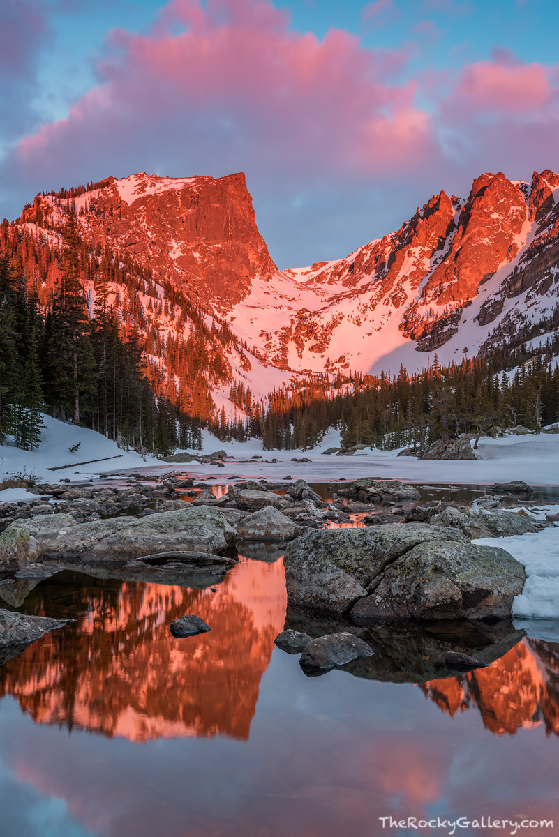 It's mid April in Rocky Mountain National Park and some of Dream Lake is still frozen from a long winters slumber. Ice is quickly...