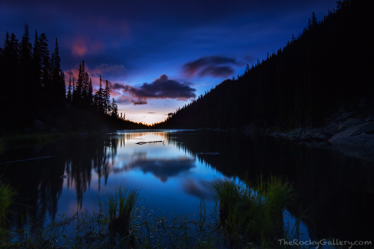 Sunrise is still 45 minutes away from illuminating the beautiful landscape around Dream Lake. Only a slight breeze ruffles the...