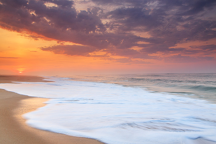 As the mornings sun crests the horizon it colors the skies of Dune Beach and Southampton a fiery red. The pounding of the aquamarine...