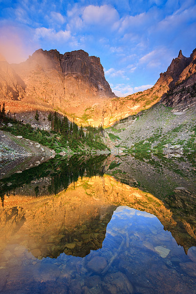 Fog hangs in the saddle below Hallet Peak as the sunrise briefly illuminates Emerald Lake. It had been raining in Rocky Mountain...