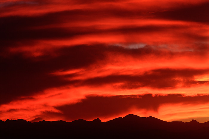 An amazing sunset unfolds along the Front Range. Pawnee peak and the Indian Peaks Wilderness turn gold in this view from Erie