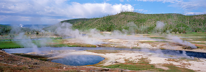 Steam from the many thermal vents along the Firehole river can be seen in one of Yellowstone National Park's more popular areas...