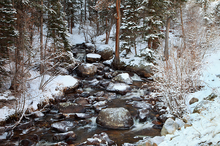 Glacier Creek in Rocky Mountain National Park is thawed and flowing freely but Winter's grip still has a hold on Rocky Mountain...