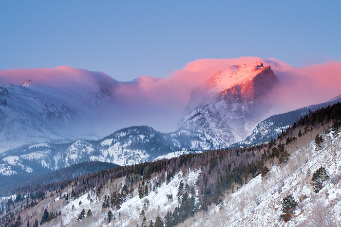 Clouds linger over Hallet Peak from a previous nights snowstorm. The storm produced only light snow over the high peaks of Rocky...