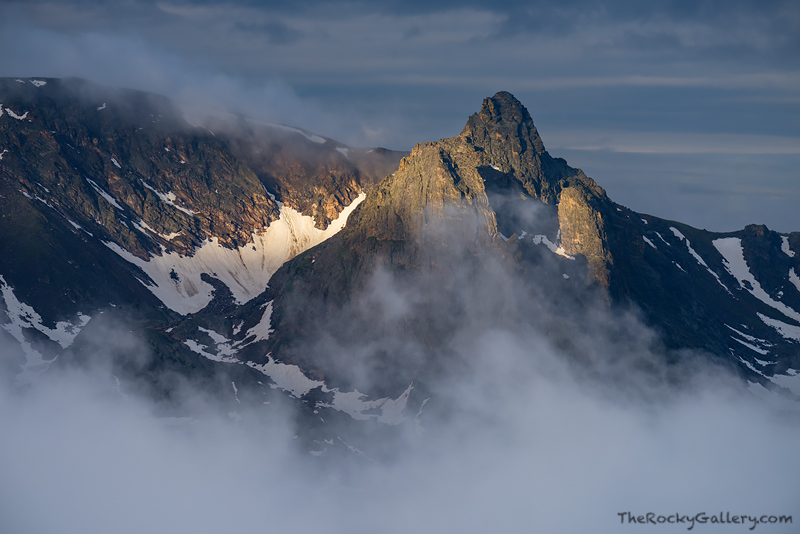 With near silence in the air and fog moving over the Hayden Spire, a drop of sunlight illumintates this ghostly tower as seen...