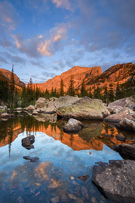 Hallet Peak basks in the glow of first light at Lake Haiyaha. The early morning sun is just peaking over the eastern plains of...