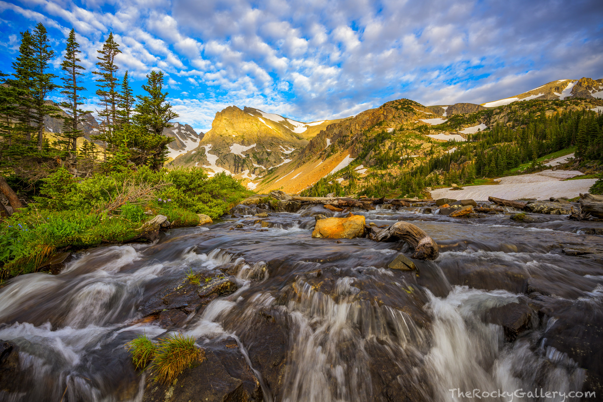 Near the outlet to Lake Isabelle in the Indian Peaks Wildnerness Area, water tumbles out of the lake on its ways eastward towards...