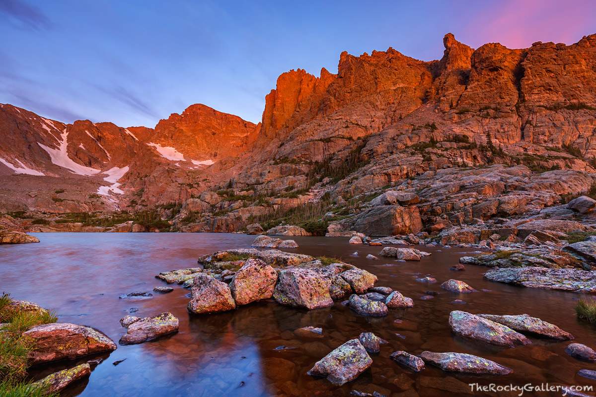 Sunrise unfolds over Taylor Peak and the Lake Of Glass high above Loch Vale in Rocky Mountain National Park. While the wind scoured...