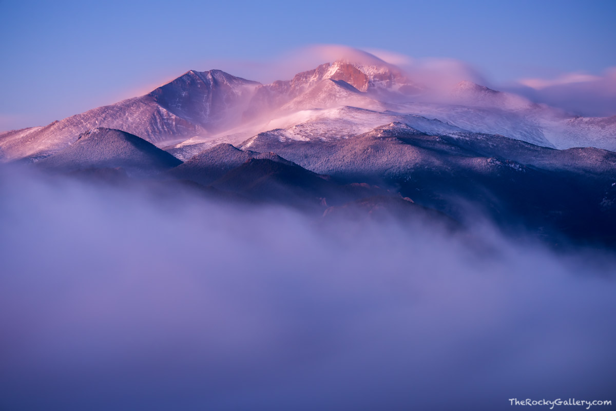 A weather system has moved in over Rocky Mountain National Park and coated the summit of Longs Peak and Mount Meeker with fresh...