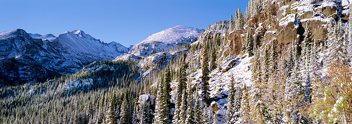 Longs Peak shines in the distance after a being coated by an early season snowstorm. Fall in Rocky Mountain National Park is...