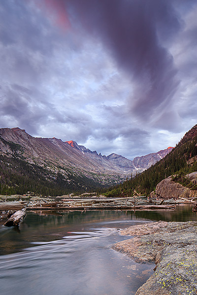 An ominous looking sky appears over Longs Peak and Mills Lake on summer morning. A storm is rolling into Rocky Mountain National...