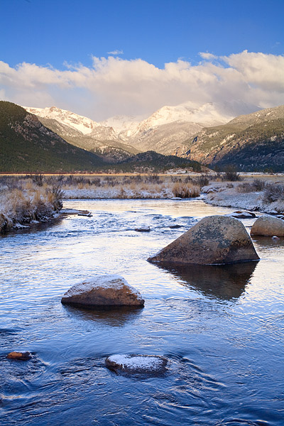 Fresh snow coats the Boulder along the Big Thompson River as winter refuses to release its grip on the divide.