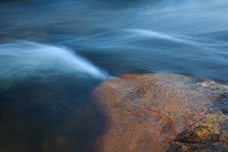 The Big Thompson River rushes through Moraine Park and past a lone rock that lines it banks. The Big Thompson is running flush...