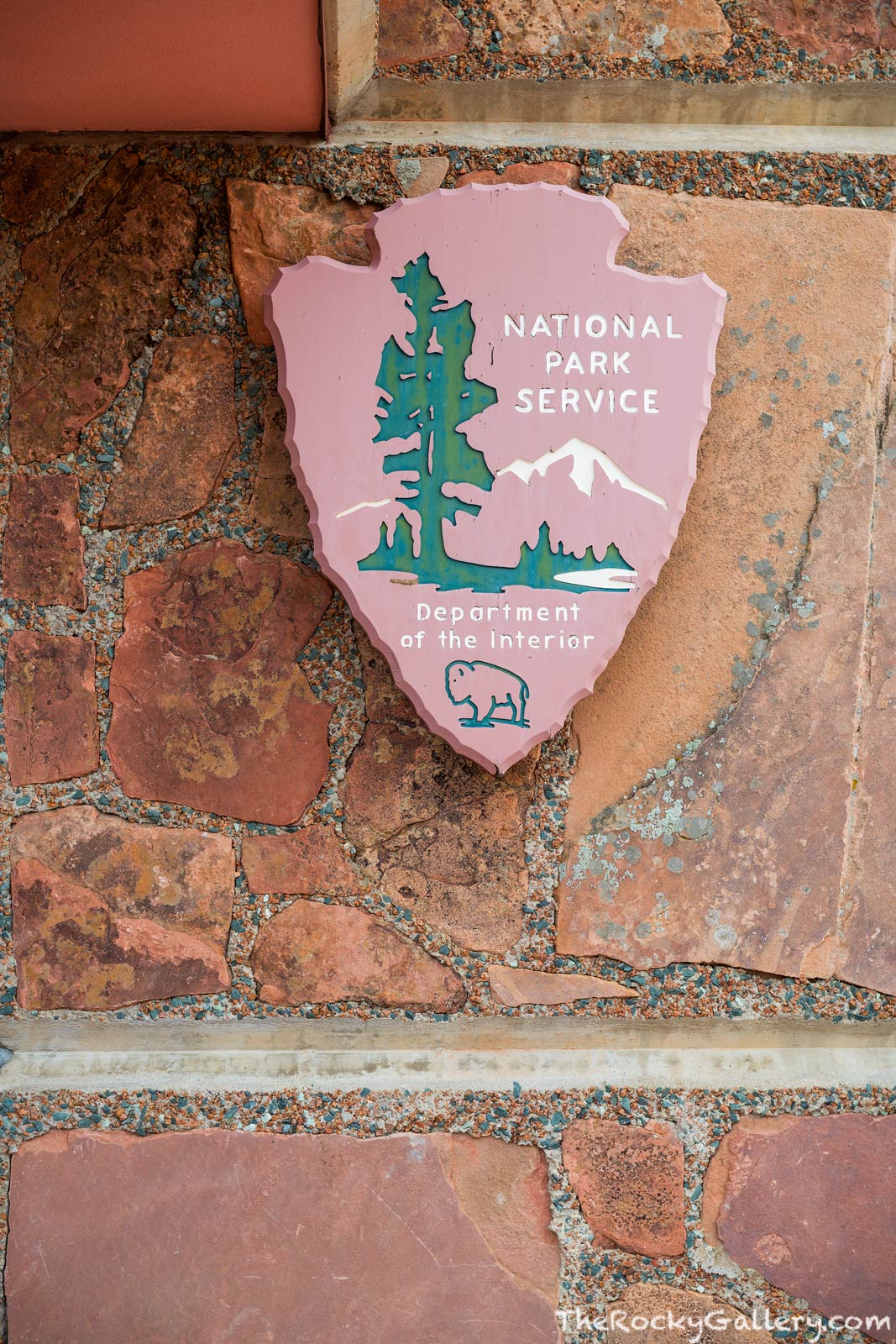 The iconic symbol of the National Park Service hangs just outside the front entry doors to the Beaver Meadows Entry Station....