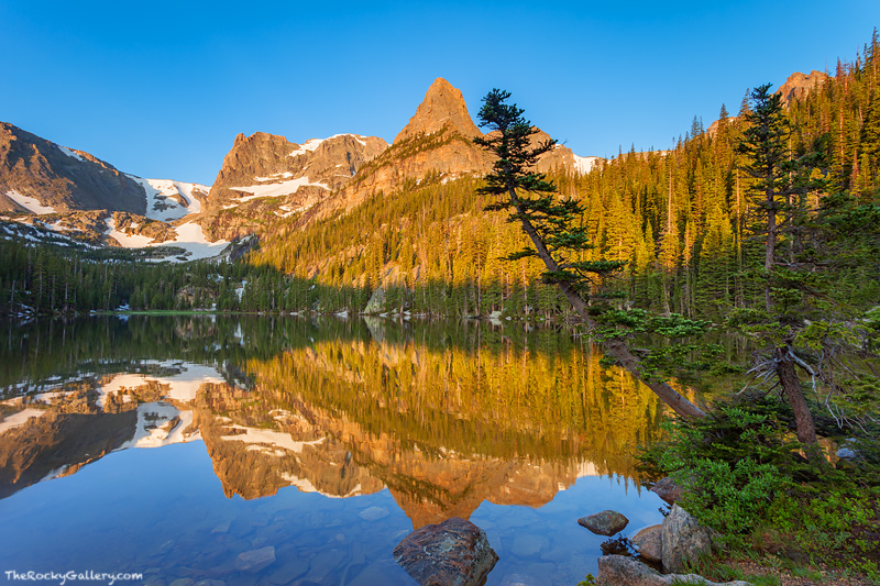 Cyrstal clear blue skies and calm winds let the Little Matterhorn and Notchtop Mountain reflect perfectly in a mirror smooth...