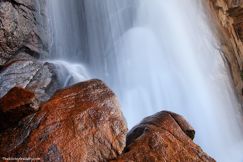 The granite boulders and rocks of Ouzel Falls are covered in water and mist and the North Saint Vrain splashes and crests over...