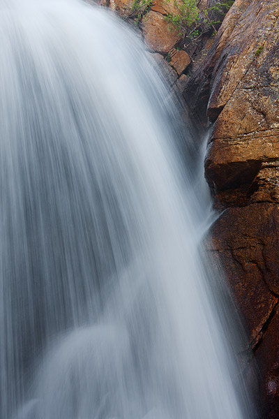 Rushing water spills over the rocks and boulders of Ouzel Falls. The North Saint Vrain Creek is running at a good clip which...