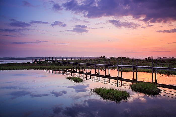 A tranquil and peaceful sunrise unfolds over Shinnecock Bay and Southampton, New York. There had been a lot of rain that had...