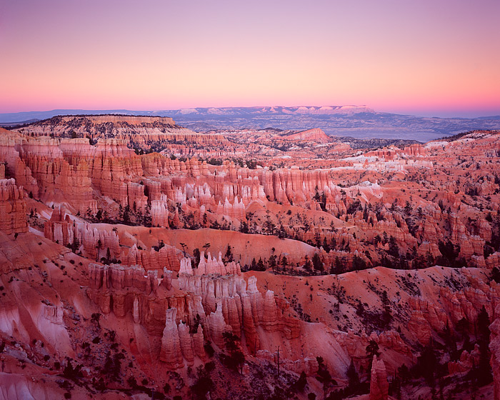 Sunset at Bryce Canyon National Park from Sunrise Point. The sun has dipped below the horizon and the Earth's shadow can be seen...