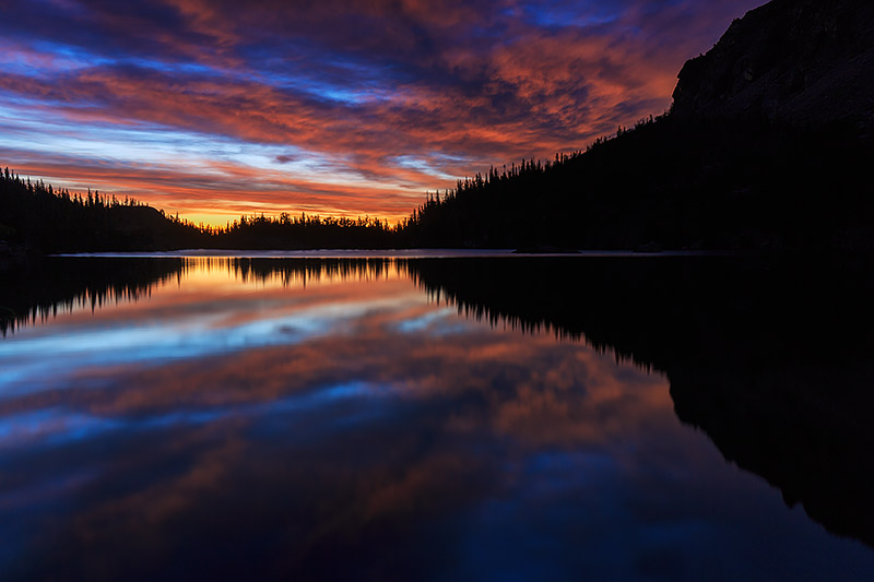 The sun has yet rise over The Loch and Loch Vale in Rocky Mountain National Park. The Loch's waters are unfettered by winds that...