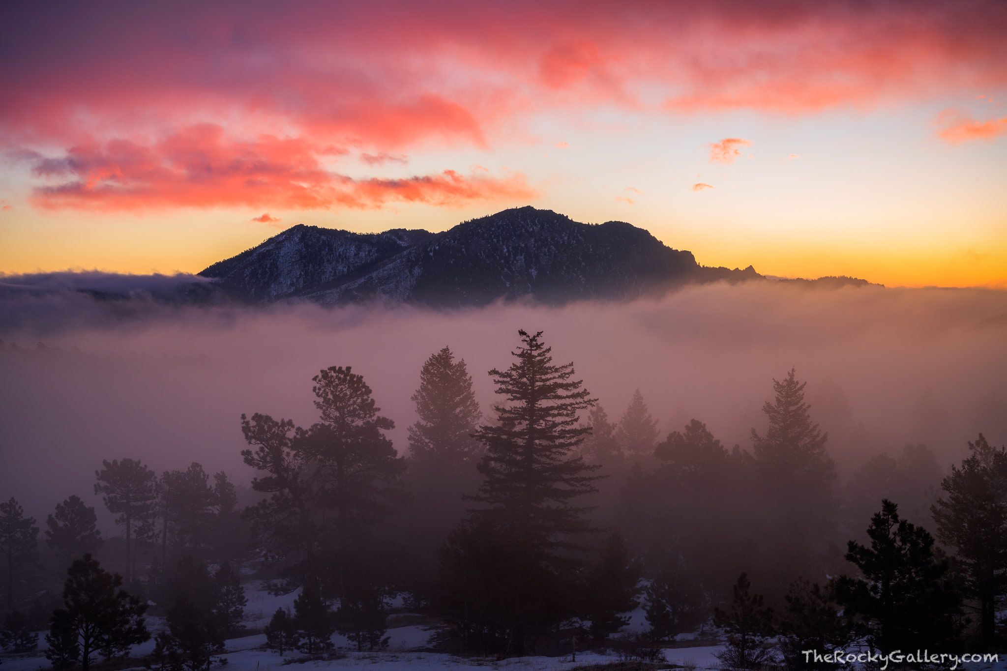 With fog covering the lower elevations at sunrise, South Boulder Peak rises above the landscape at sunrise as seen from Walker...