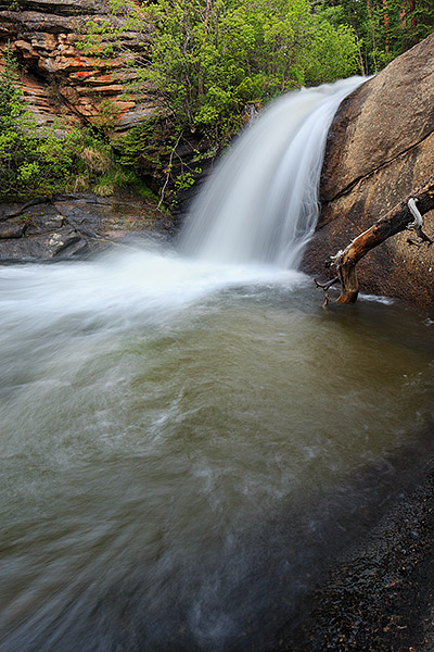 West Creek Falls plunges over granite and into a pool of cool water at the upper falls. West Creek Falls is located just inside...