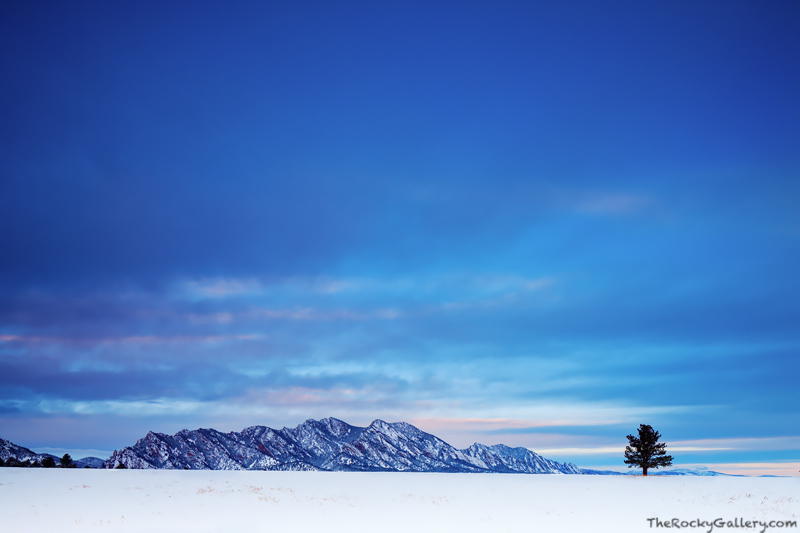 A subdued Winter sunrise along the Flatirons of Boulder made for some dramatic lighting. This view near the Flatirons Vista open...
